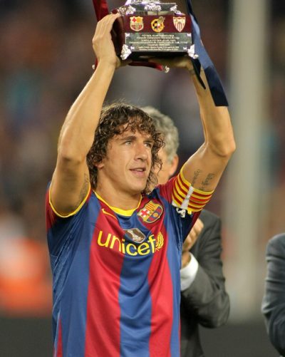 BARCELONA - AUGUST 21: Carles Puyol of Barcelona holds up the sp