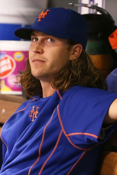 DENVER-AUG 21: New York Mets pitcher Jacob deGrom sits in the du